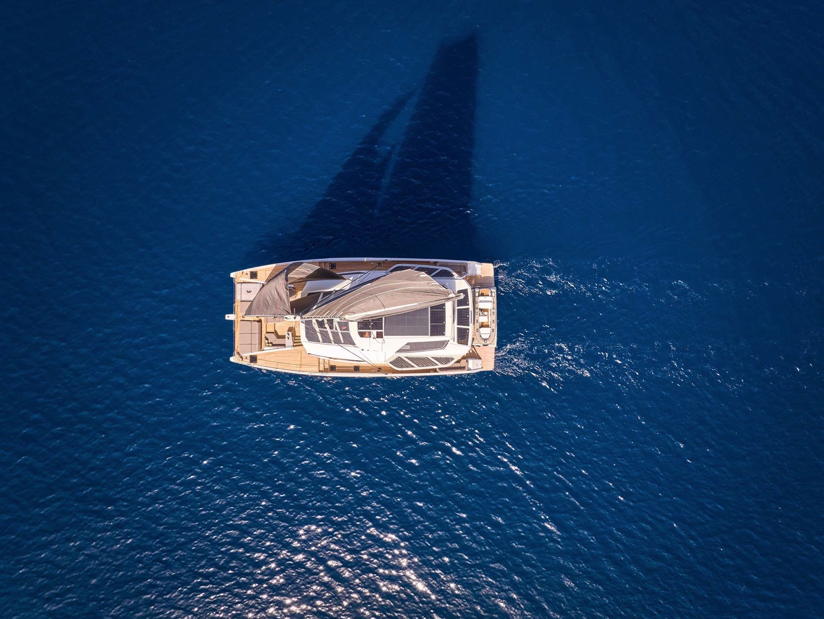 Fountaine Pajot Thira 80 catamaran sailing with the Aloia 80 expedition yacht visible on open water