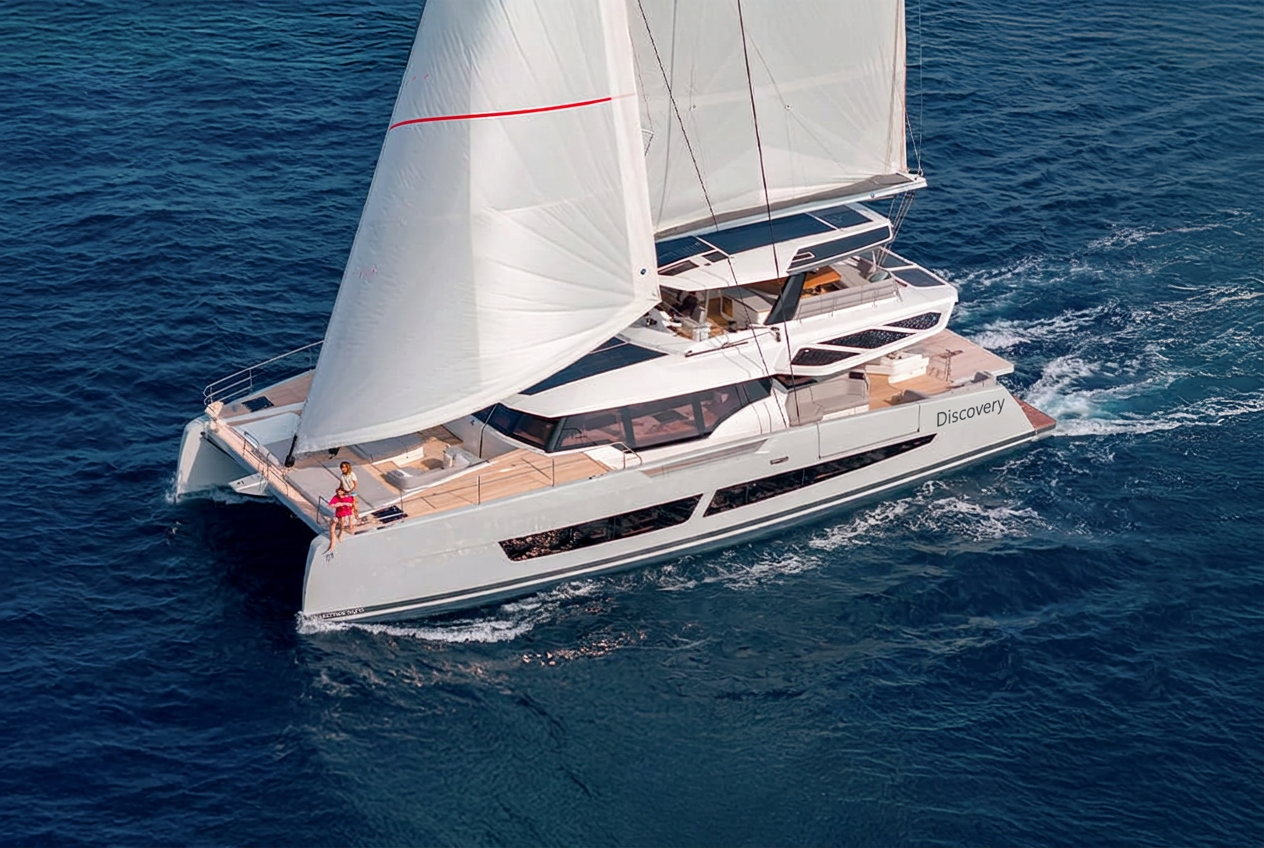 Aerial view of the Fountaine Pajot Thira 80 catamaran sailing with full sails across the deep blue ocean